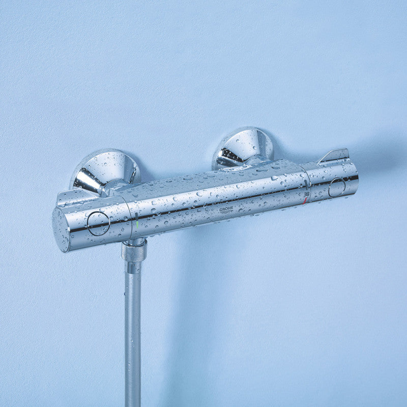 Mitigeur thermostatique de douche Grohe chromé, robinetterie murale brillante gouttes d'eau