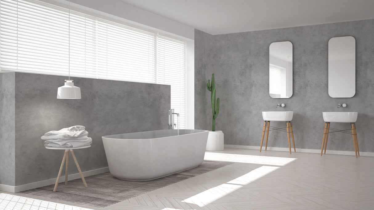 Salle de bain moderne avec béton ciré Mat Perle Vipanel, murs gris clair, baignoire design.
